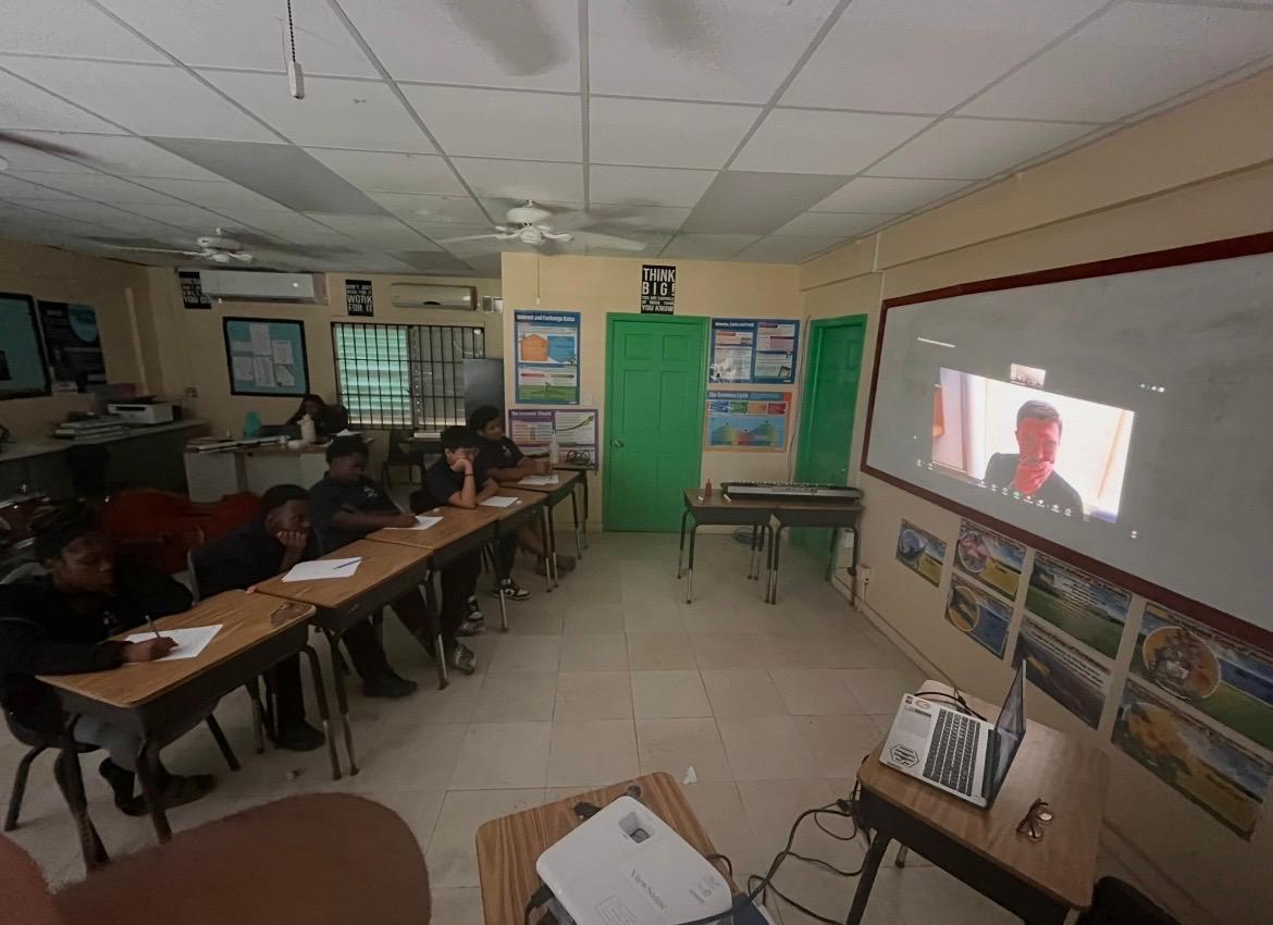 Island Innovators Bahamas 2026 students watching a guest speaker projected on screen