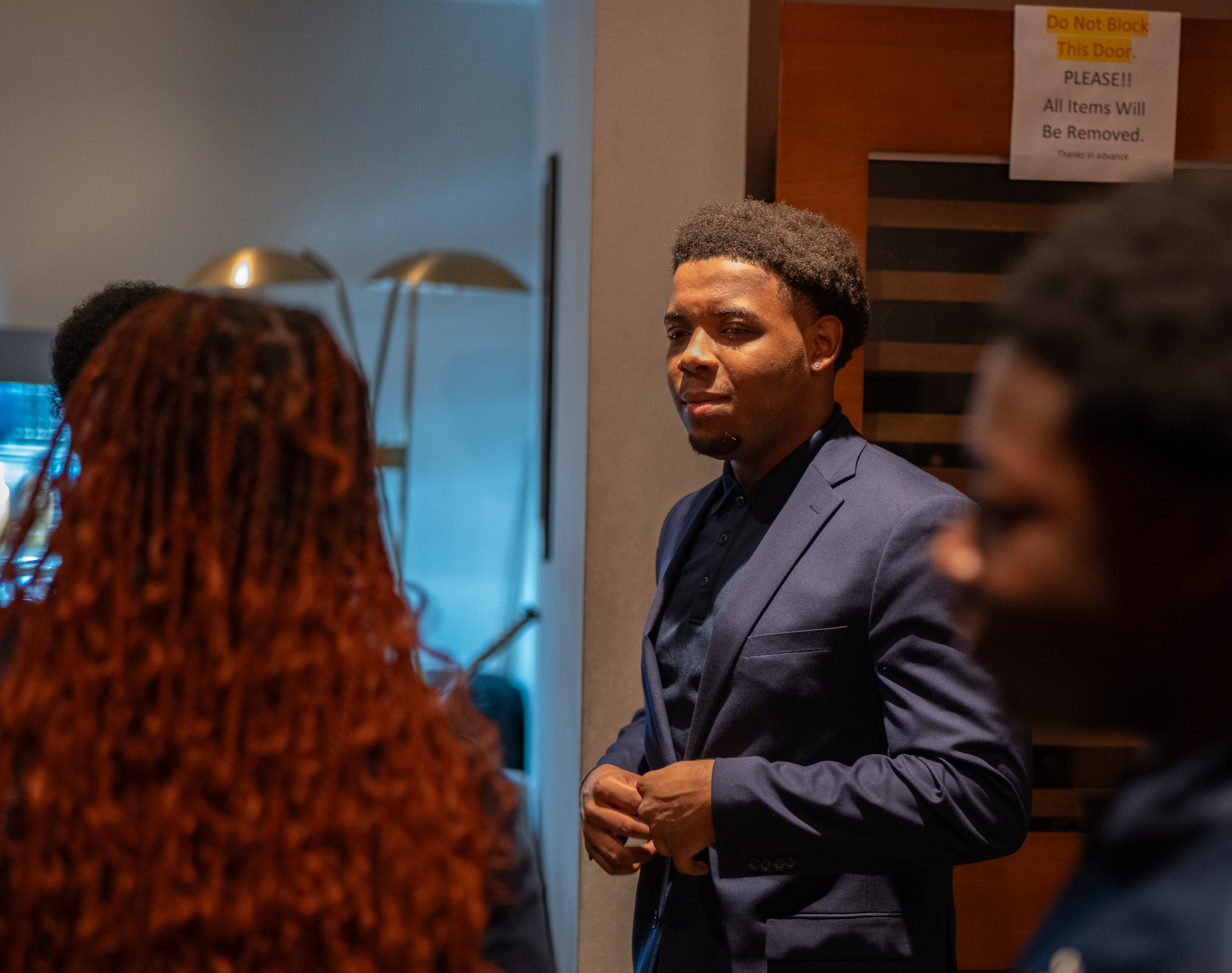 Christopher Hilton in conversation at Jon Batiste's Jazz Club with Island Innovators Bahamas students nearby