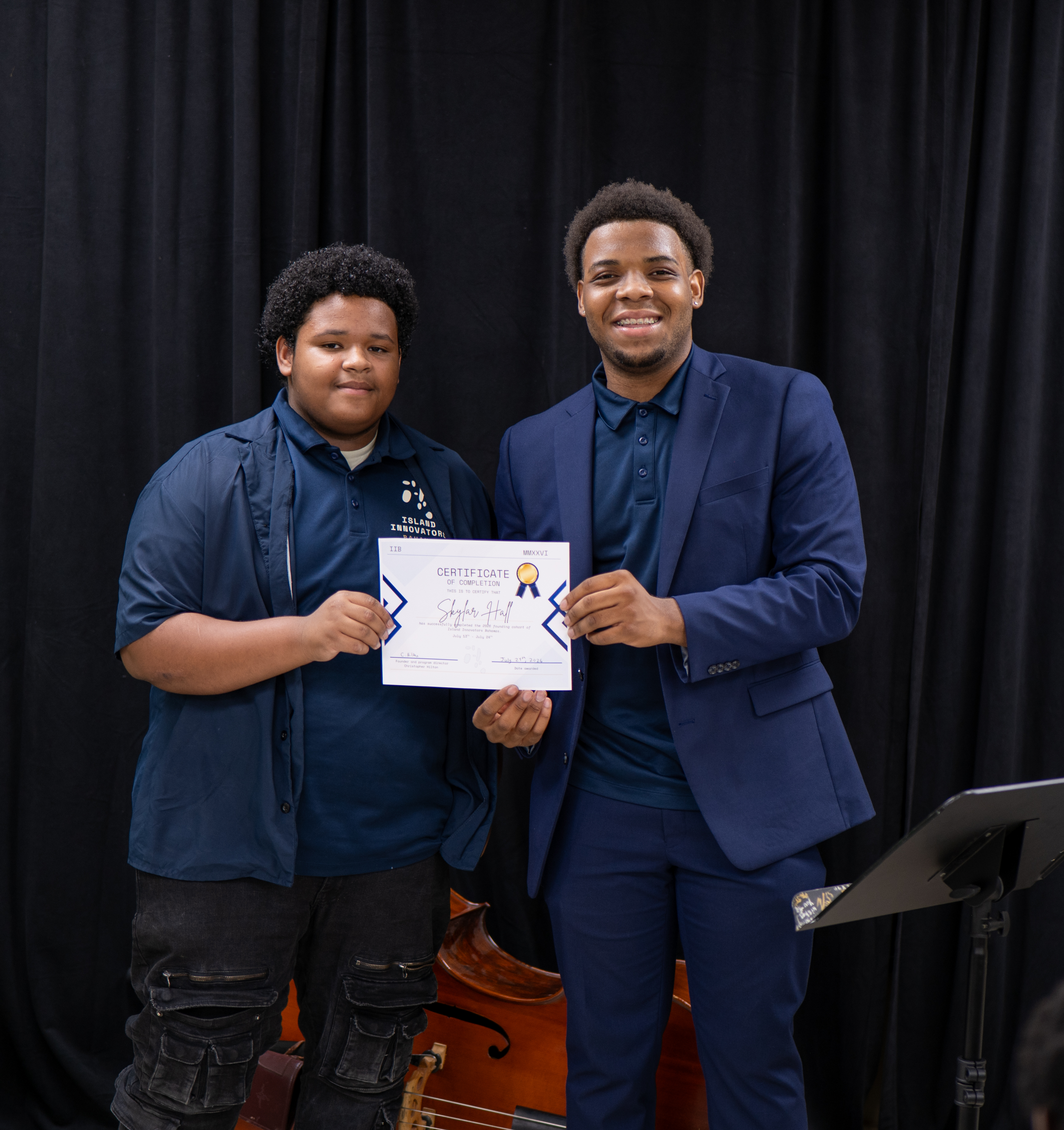 Christopher Hilton presenting a certificate of completion to a student at the 2026 IIB showcase