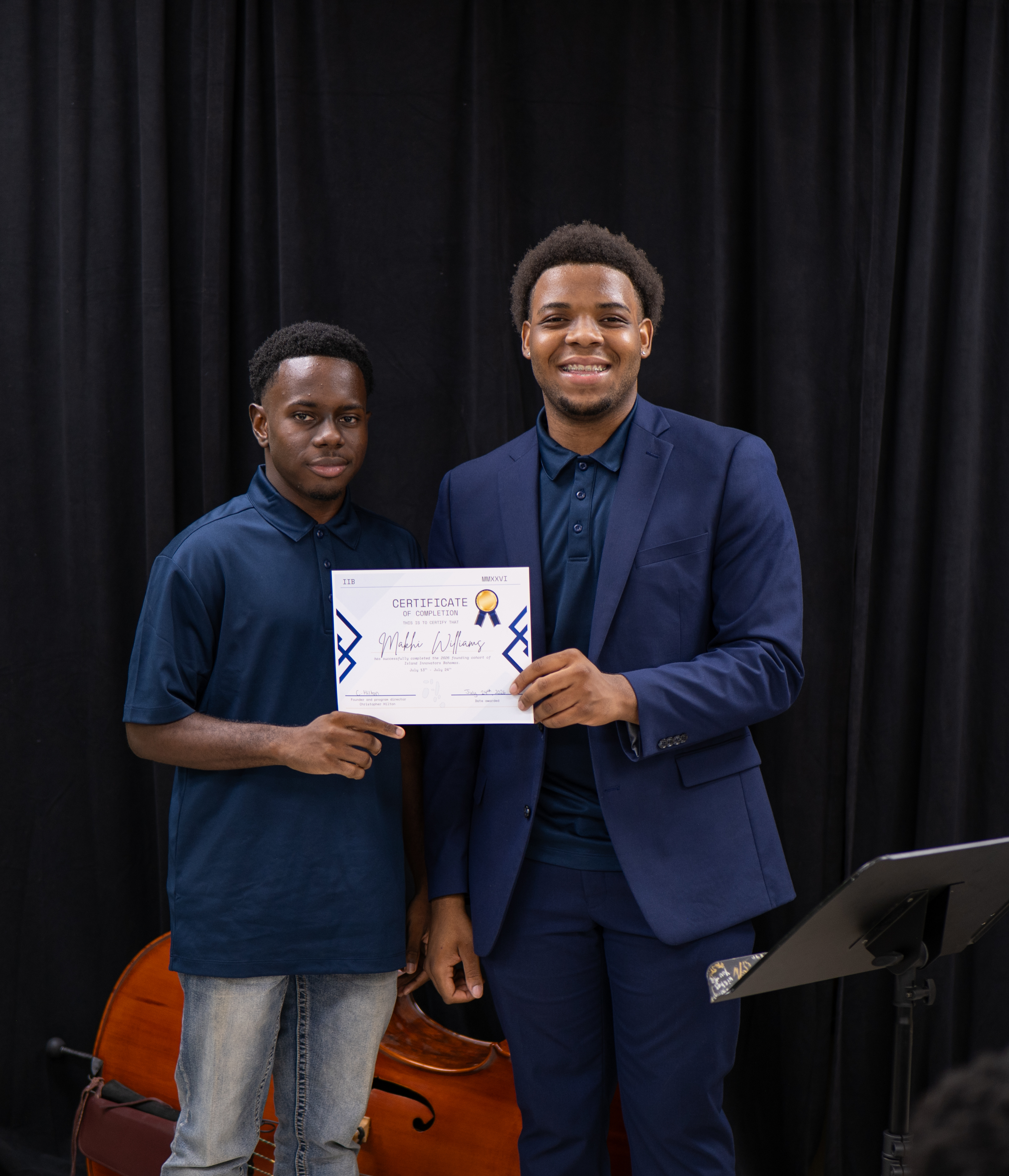 Christopher Hilton presenting a certificate of completion to a student at the 2026 IIB showcase