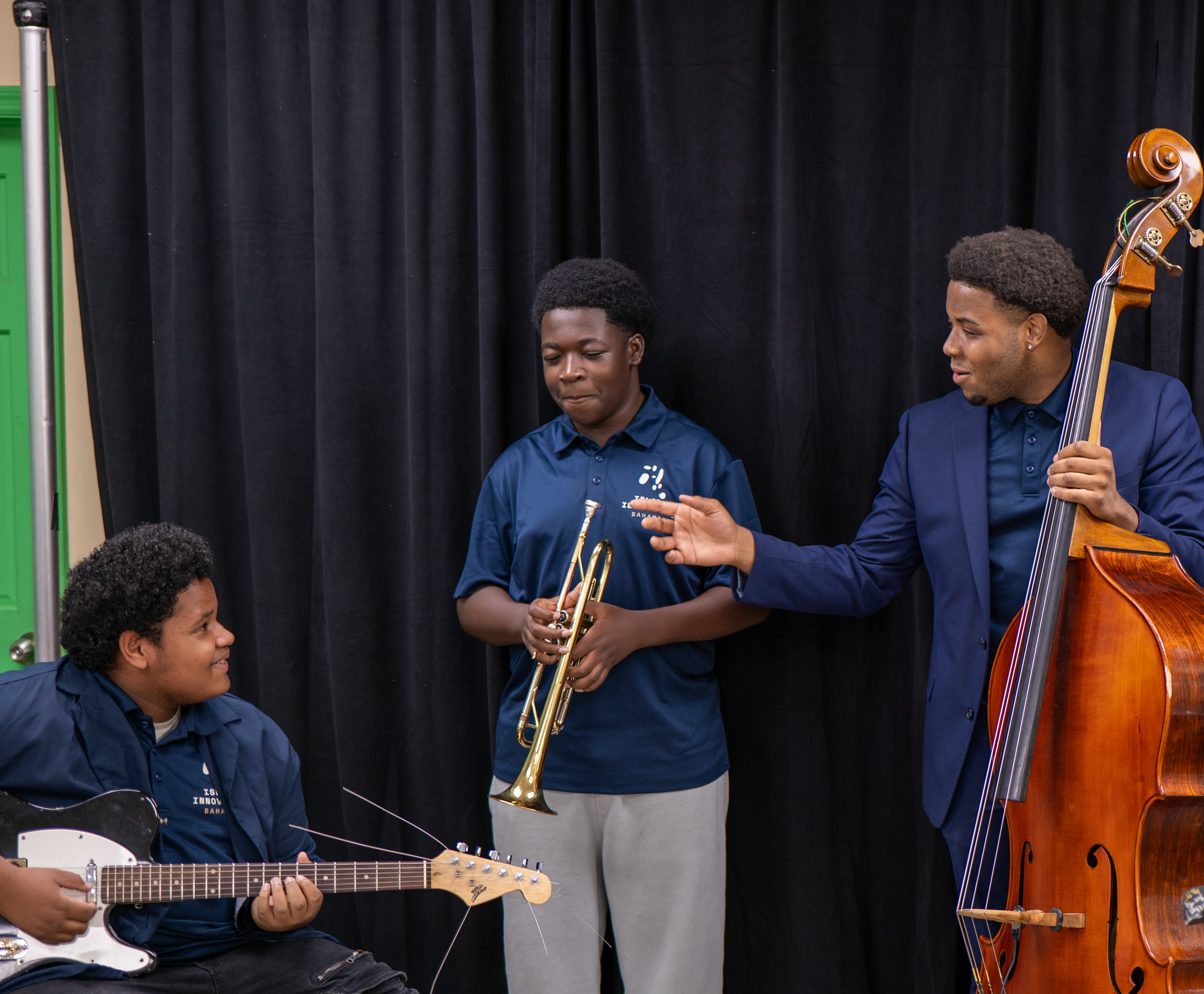 Christopher Hilton working with students on trumpet and guitar before the showcase