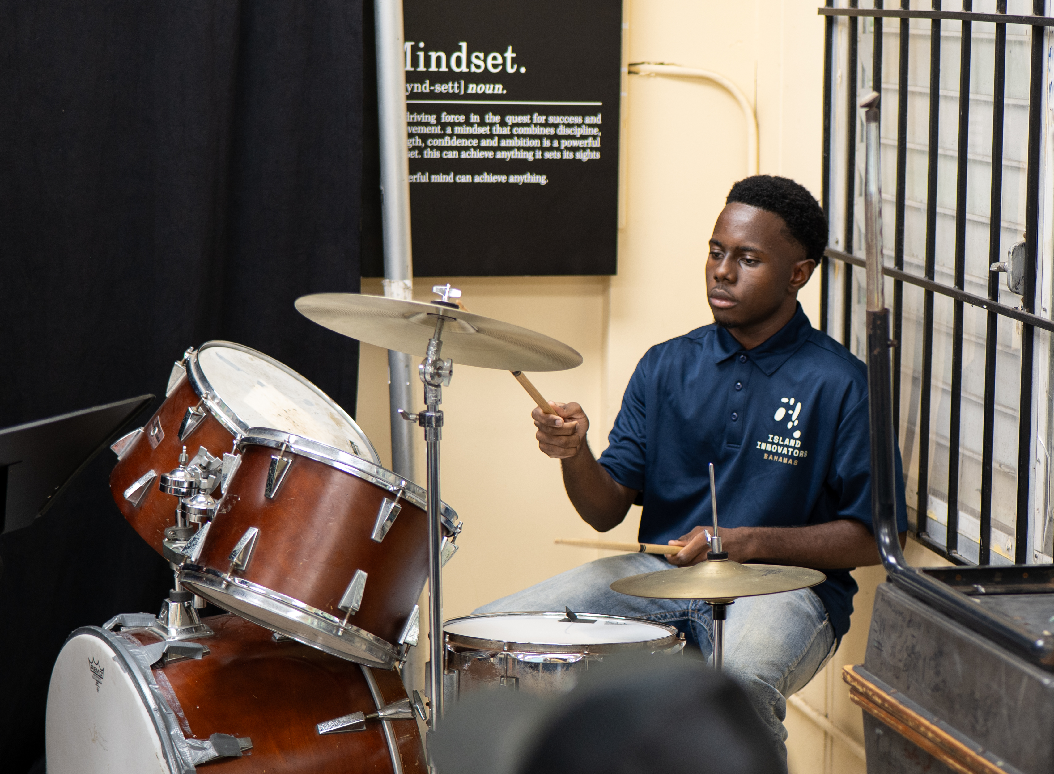 Island Innovators Bahamas 2026 student performing drums at the public showcase